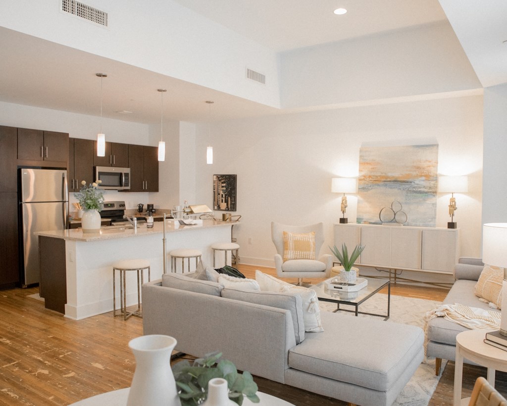 a living room and kitchen with a couch and a table
