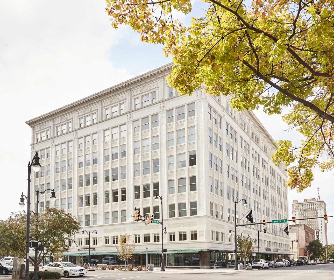 a large white building on the corner of a city street