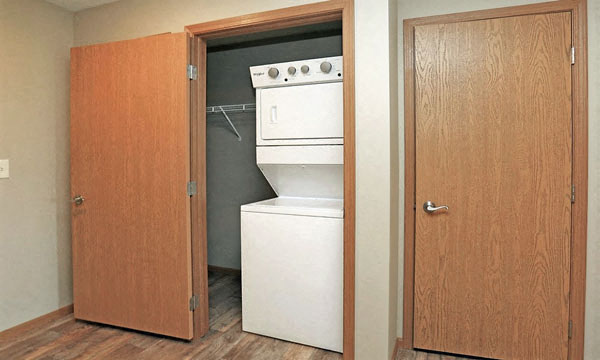 an open closet with a white stove in it