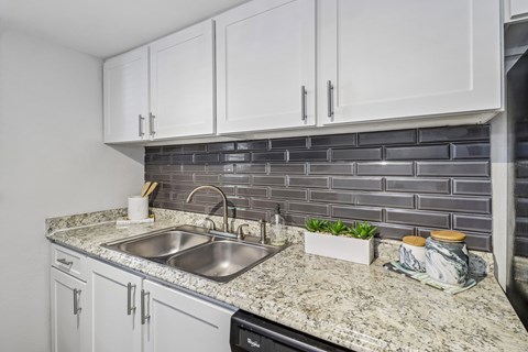 A kitchen with a sink and a counter.