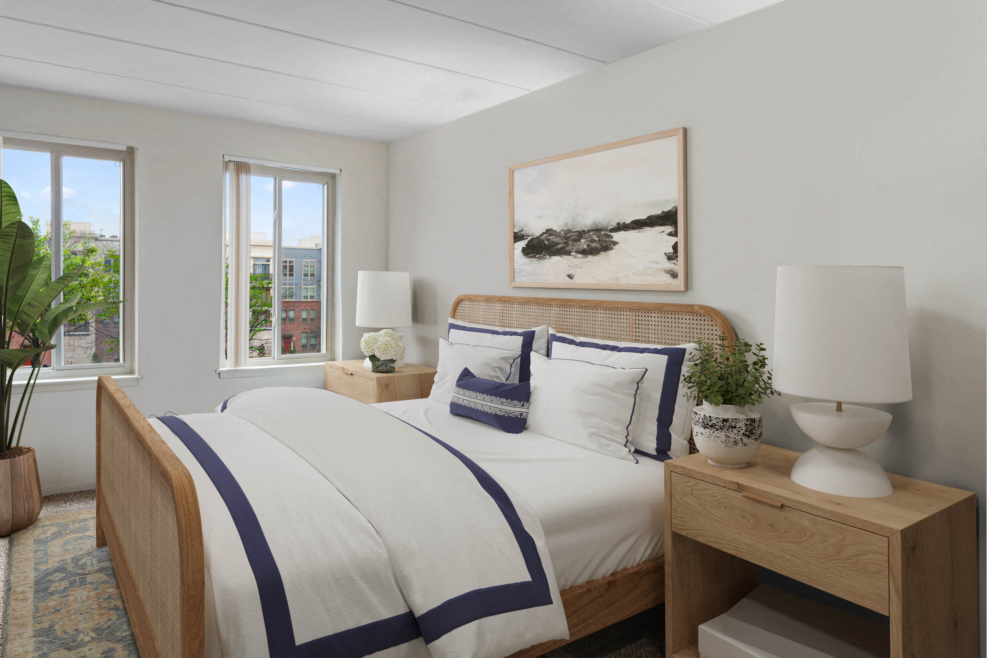 a bedroom with two beds and two windows