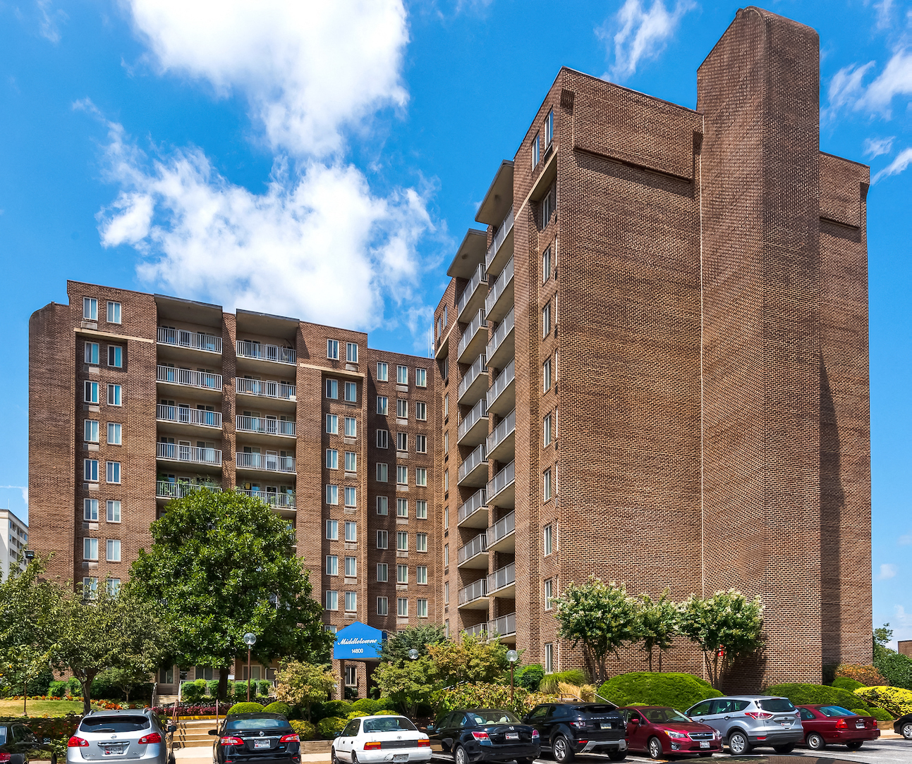 a large brick building with cars parked in front of it