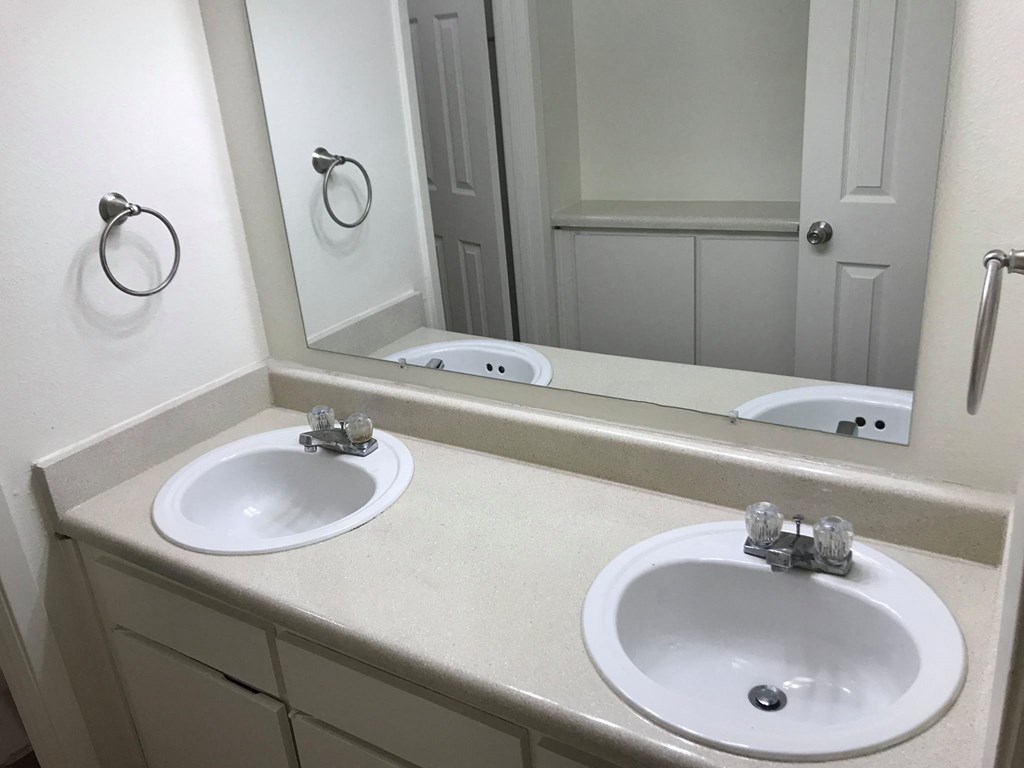 a bathroom with two sinks and a mirror