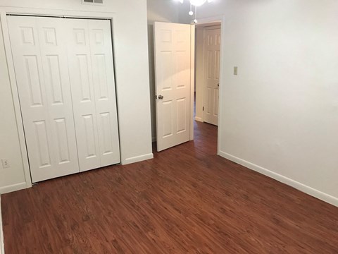 a living room with wood flooring and white doors