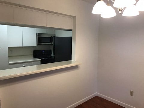 a kitchen with a large mirror and a black stove and microwave