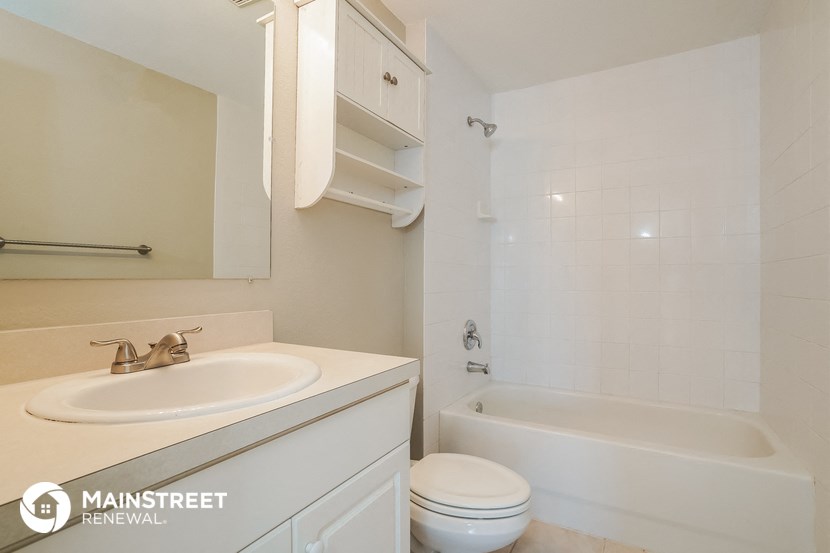 a bathroom with a sink and a toilet and a bath tub