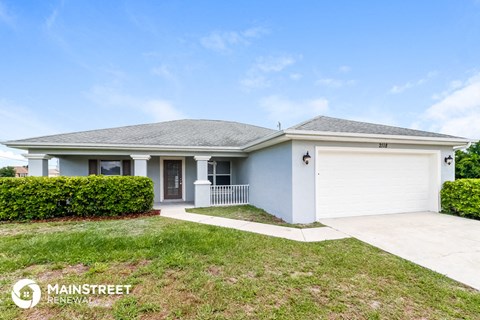 a white house with a lawn and a white garage door