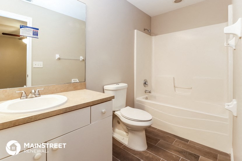a bathroom with a sink toilet and a bath tub