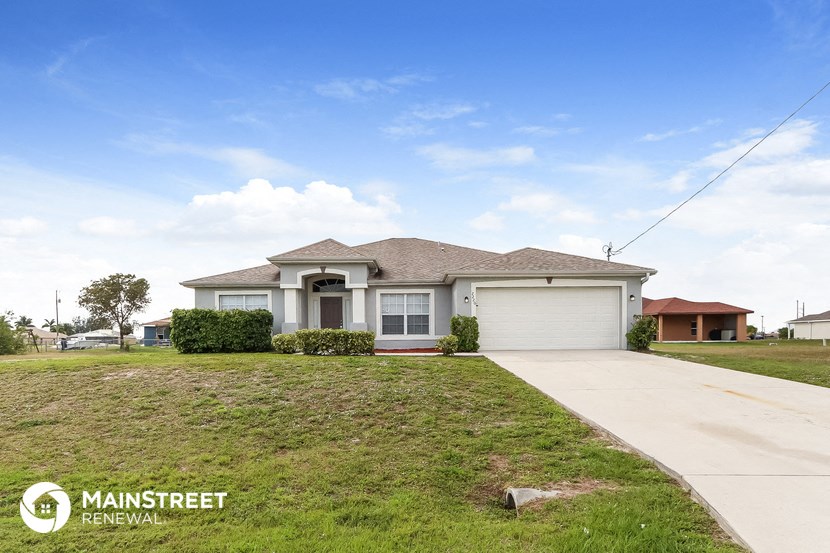 a house with a lawn and a sidewalk