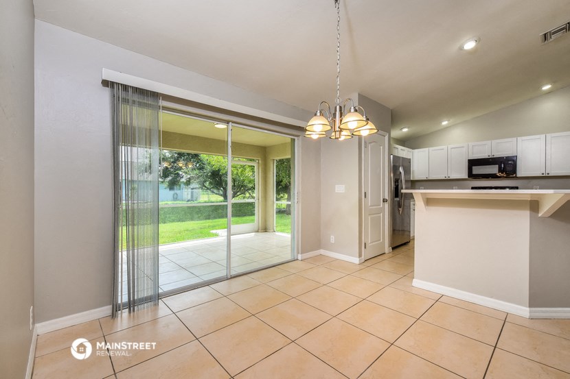 a kitchen and dining room with sliding glass doors to the yard