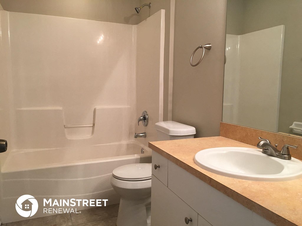 a bathroom with a sink and a toilet and a tub