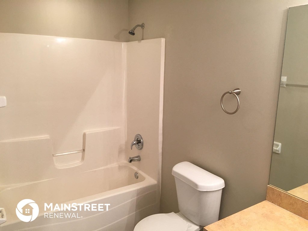 a bathroom with a tub and a toilet and a sink