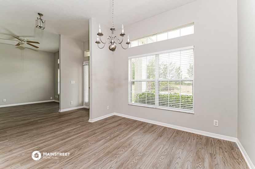 the living room of an empty house with a large window
