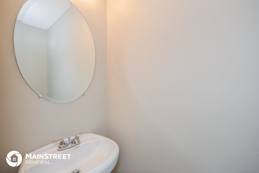 a white bathroom with a mirror and a sink