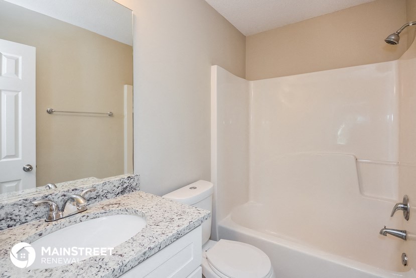 a bathroom with a sink and a toilet and a shower