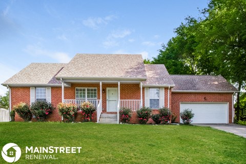 a brick house with a lawn in front of it