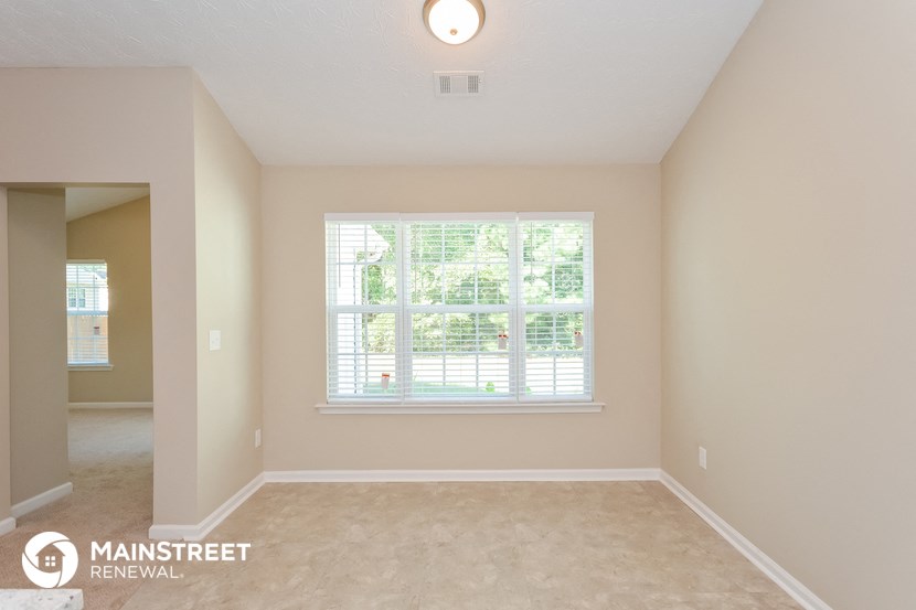 an empty living room with a large window