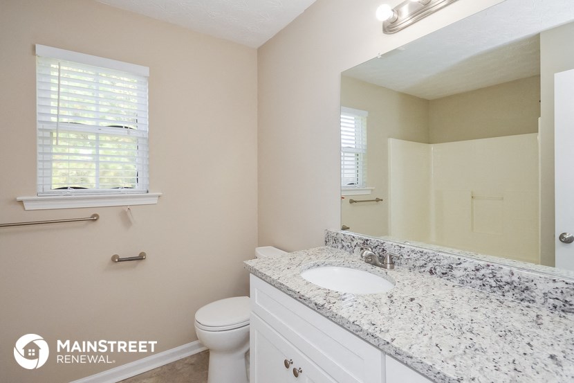 a bathroom with a sink and a toilet and a mirror