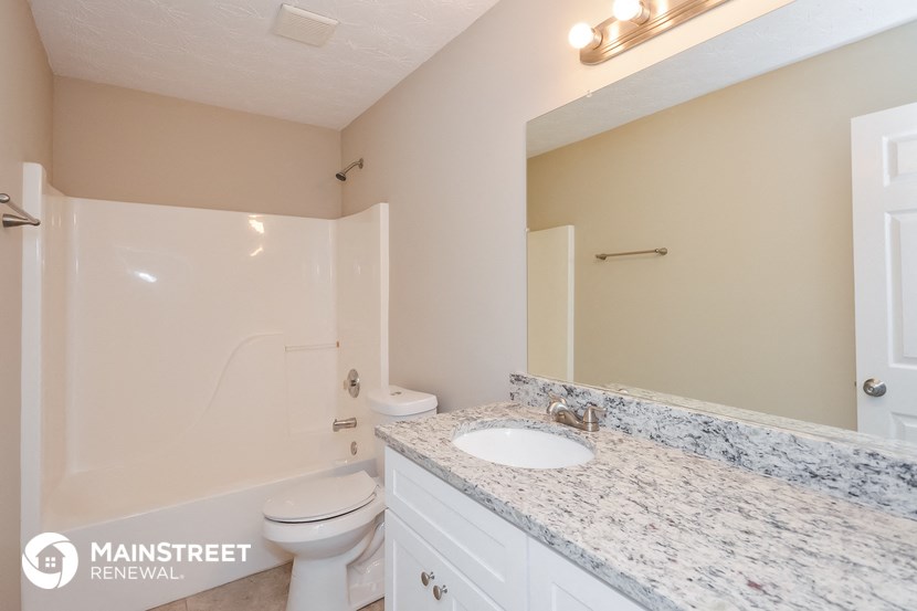 a bathroom with a sink and a toilet and a shower