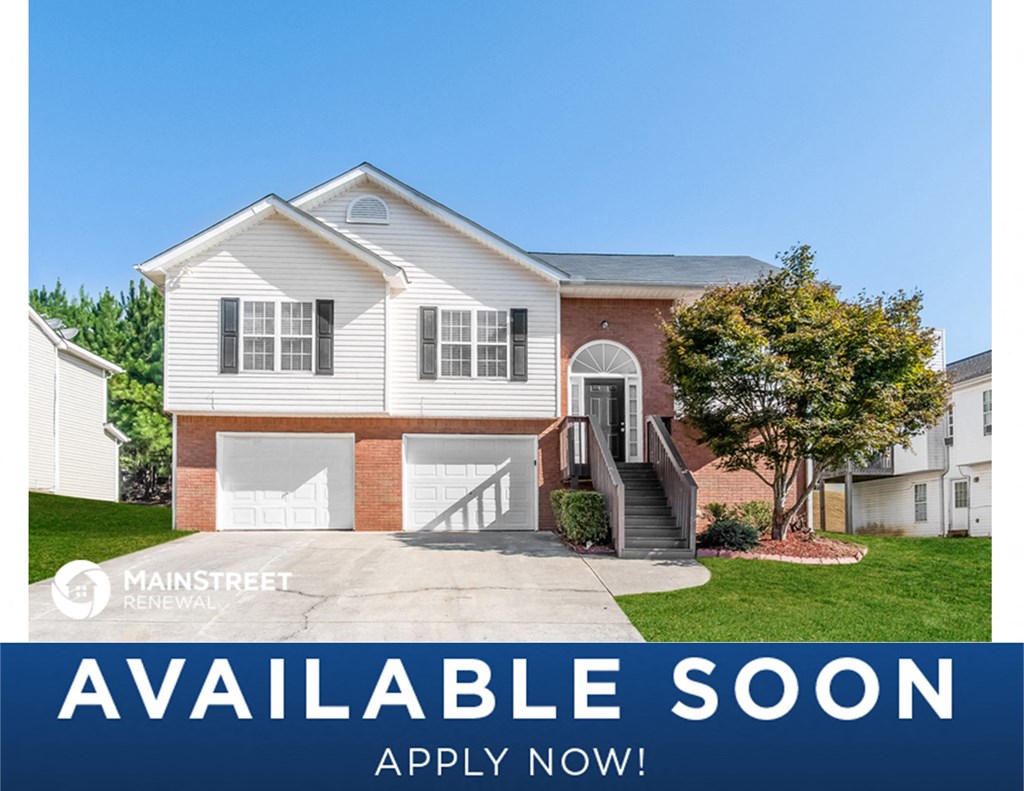 a white house with a driveway and a sign that reads available soon