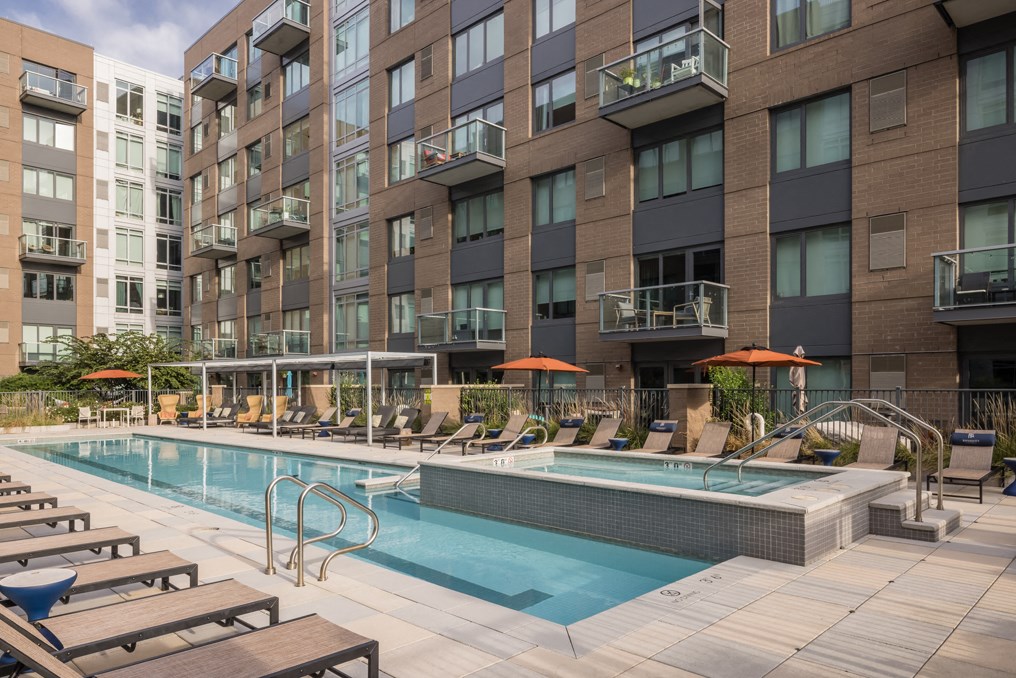 a swimming pool in front of a tall building