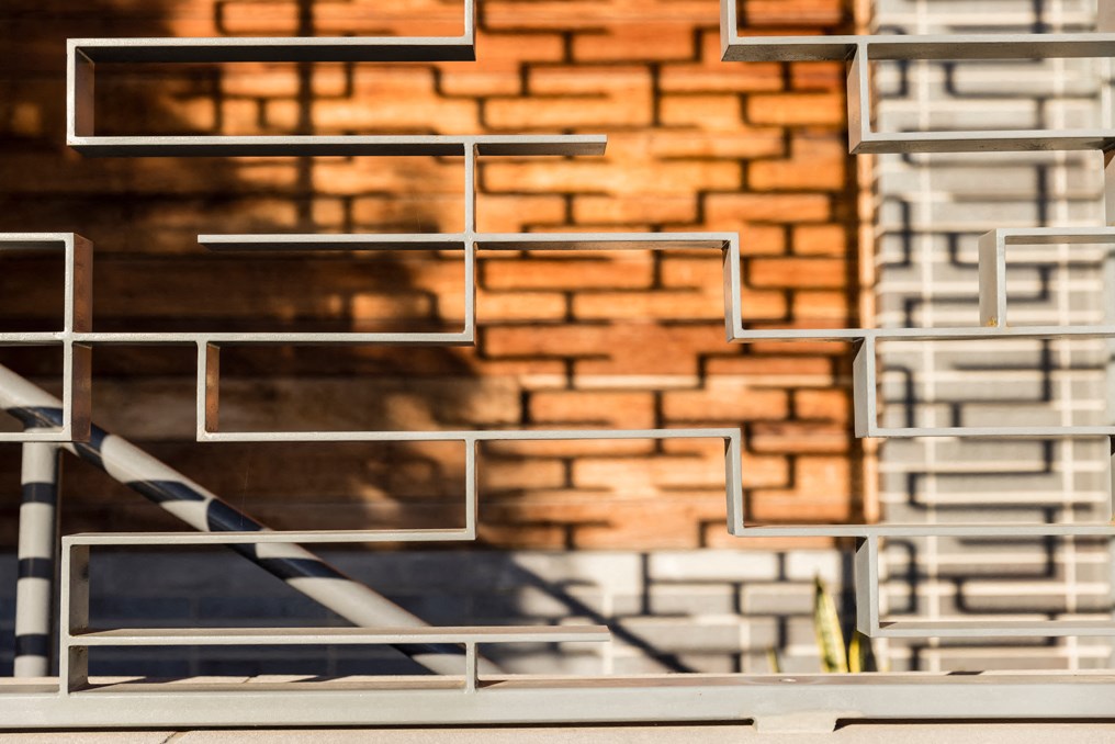 the facade of a building with a brick wall and stairs