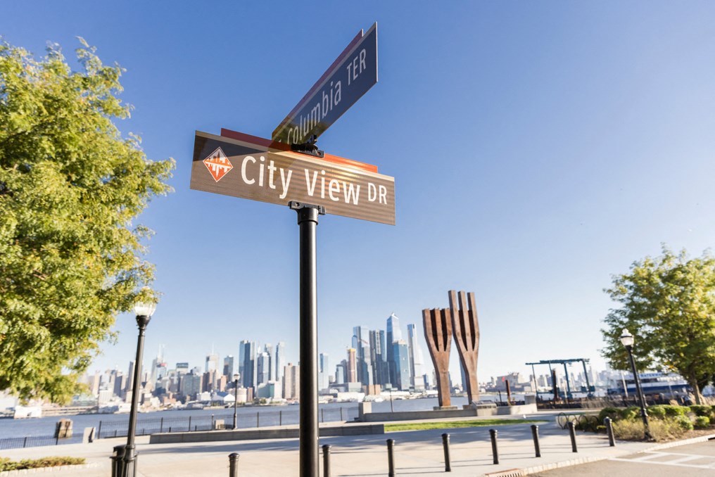 the city view dr sign with the city skyline in the background
