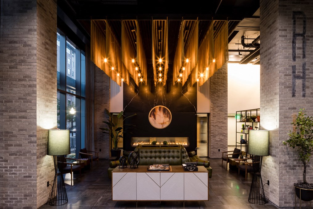 the lobby of a hotel with a couch and a table