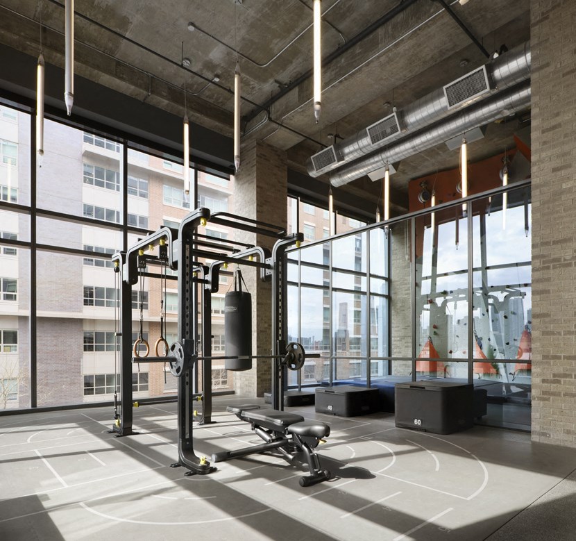 a gym with a basketball court and gym equipment in a loft