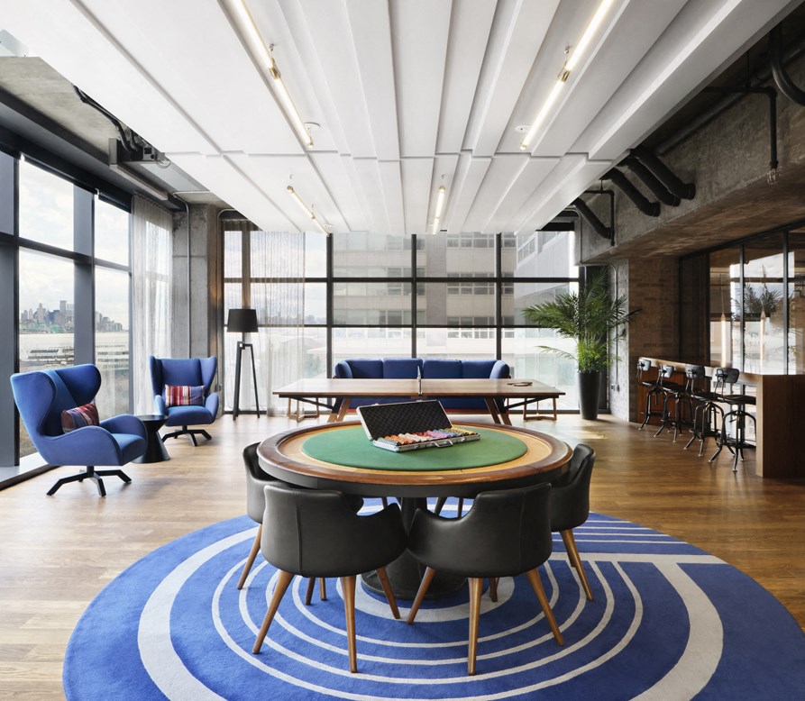a large room with a table with a laptop on top of it