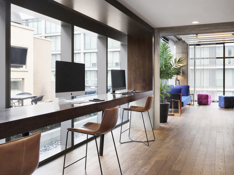 a large office space with desks and chairs and a large window