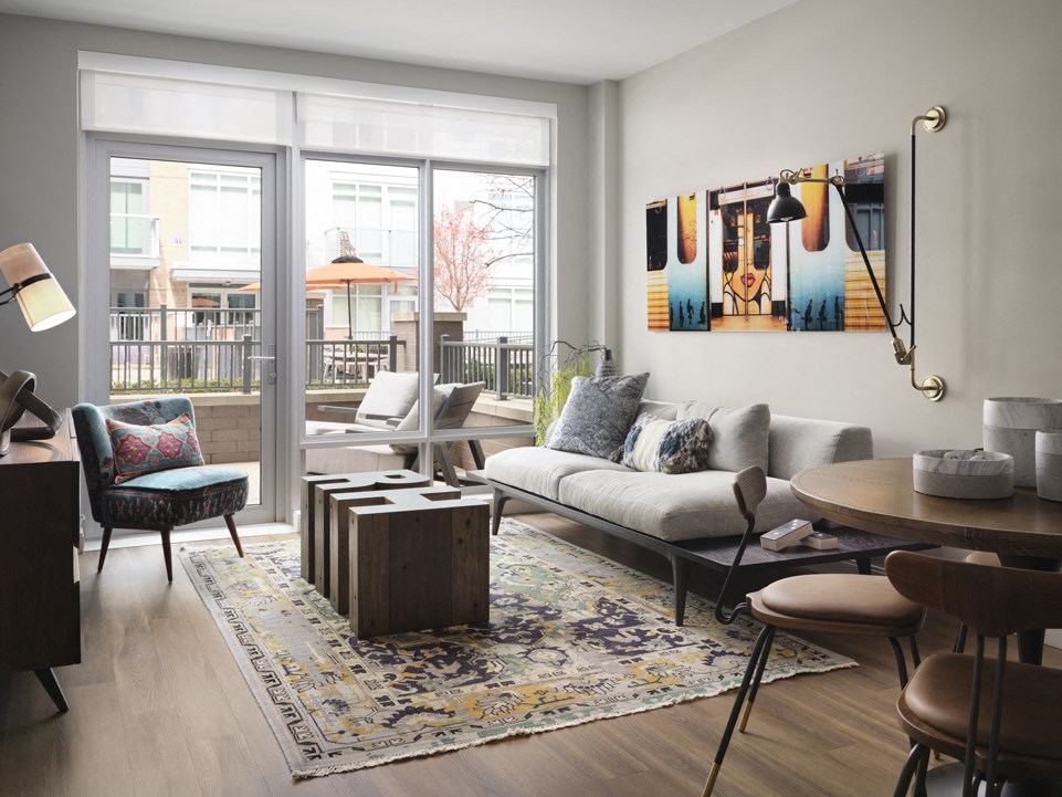 a living room with a couch and a table   and a balcony