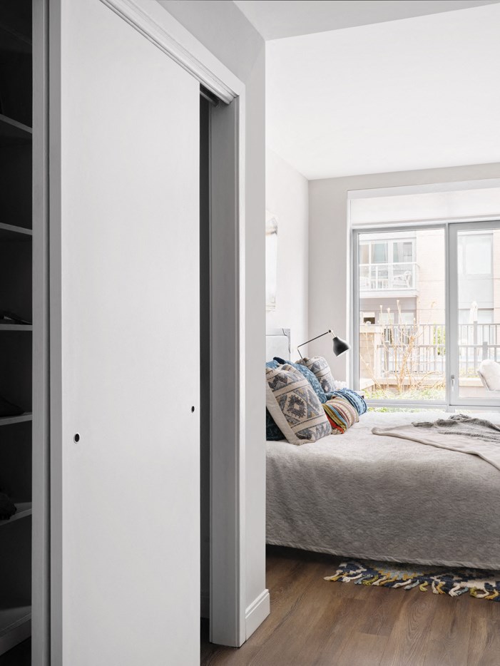a bedroom with a bed and a sliding glass door