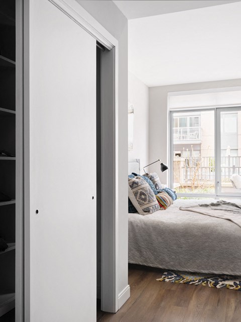 a bedroom with a bed and a sliding glass door