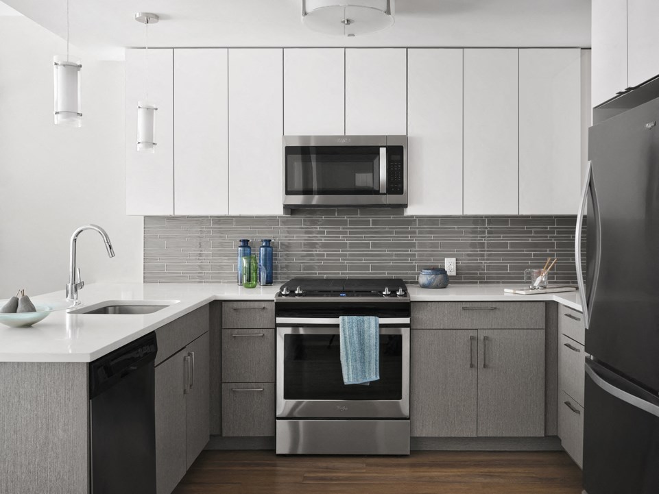 a kitchen with stainless steel appliances and white cabinets