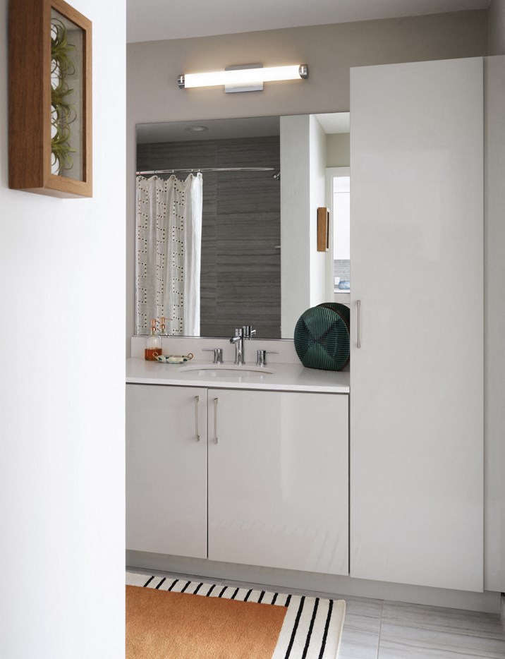 a bathroom with white cabinets and a sink and a mirror