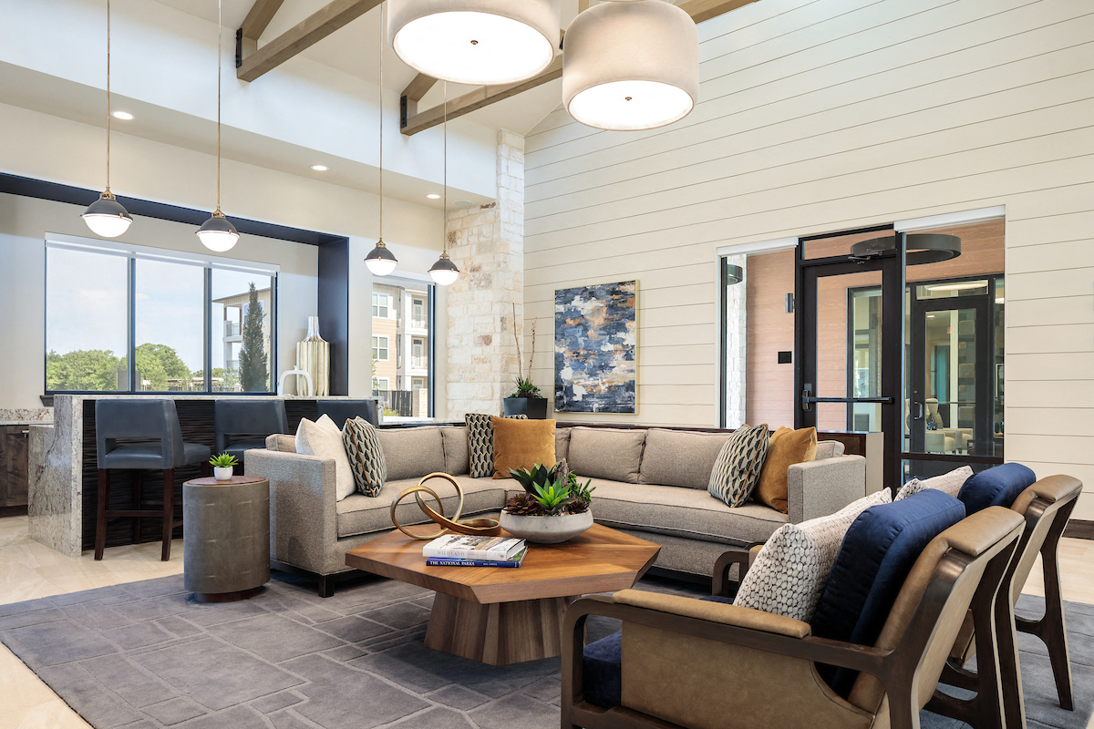 A modern living room with a large sectional sofa and a coffee table.