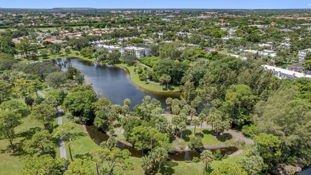 an aerial view of a park with a lake