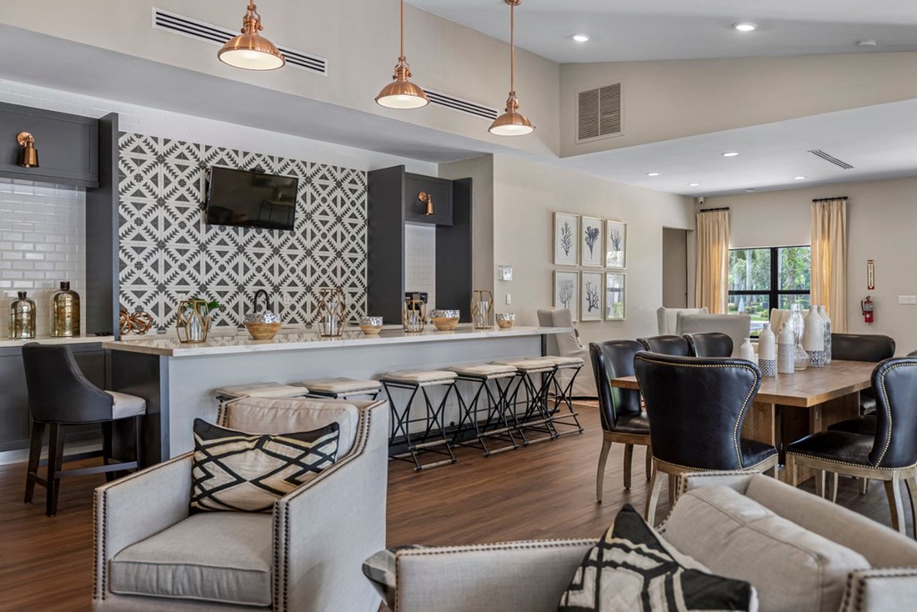 a living room with a bar and a dining room