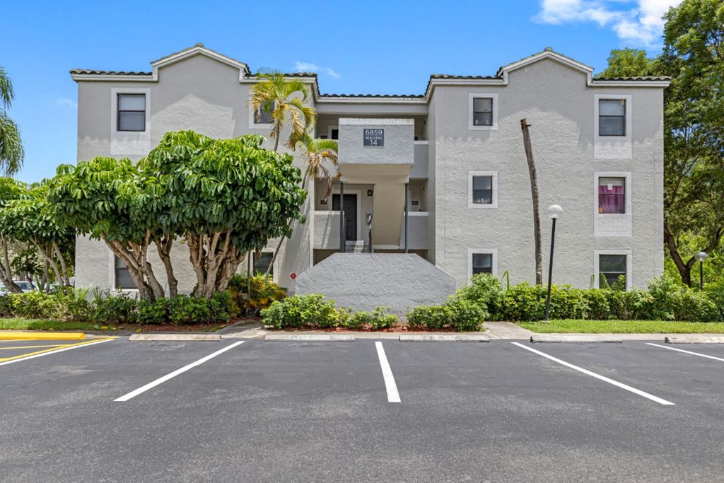 a large white building with trees in front of it