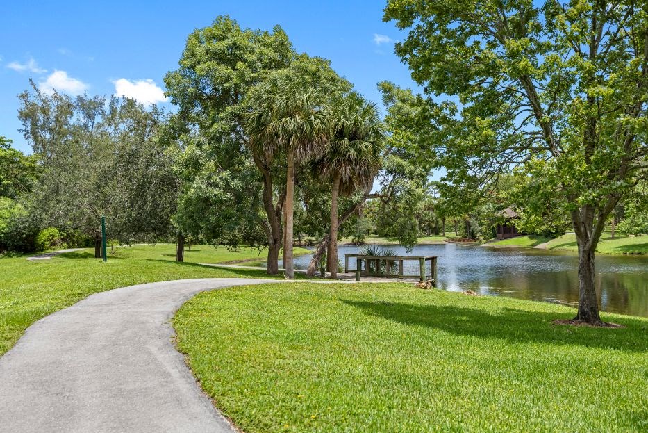 a path through a park next to a body of water