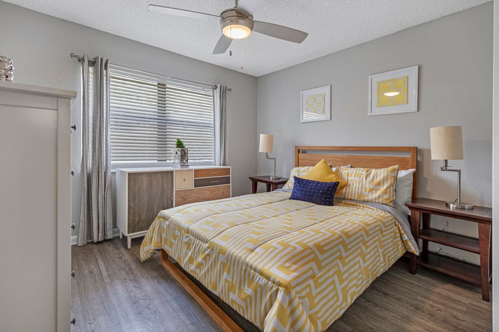 a bedroom with a bed and a ceiling fan