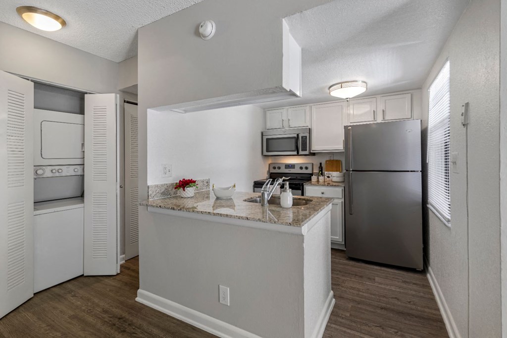 a kitchen with stainless steel appliances and a counter top