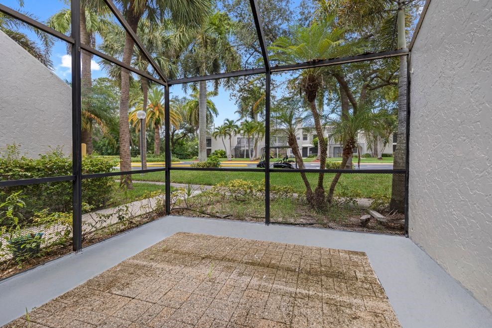 a living room with a large glass window and a rug on the floor