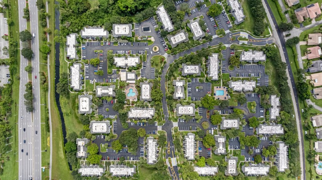 an aerial view of a city with houses and trees
