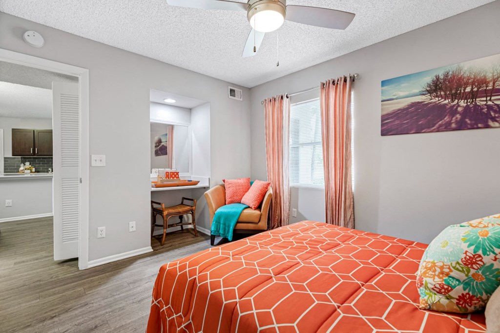 a bedroom with a bed and a ceiling fan