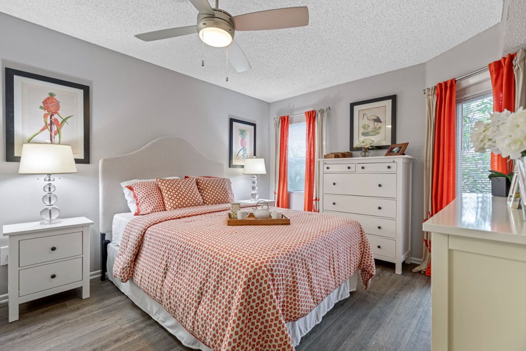 a bedroom with a bed and a ceiling fan