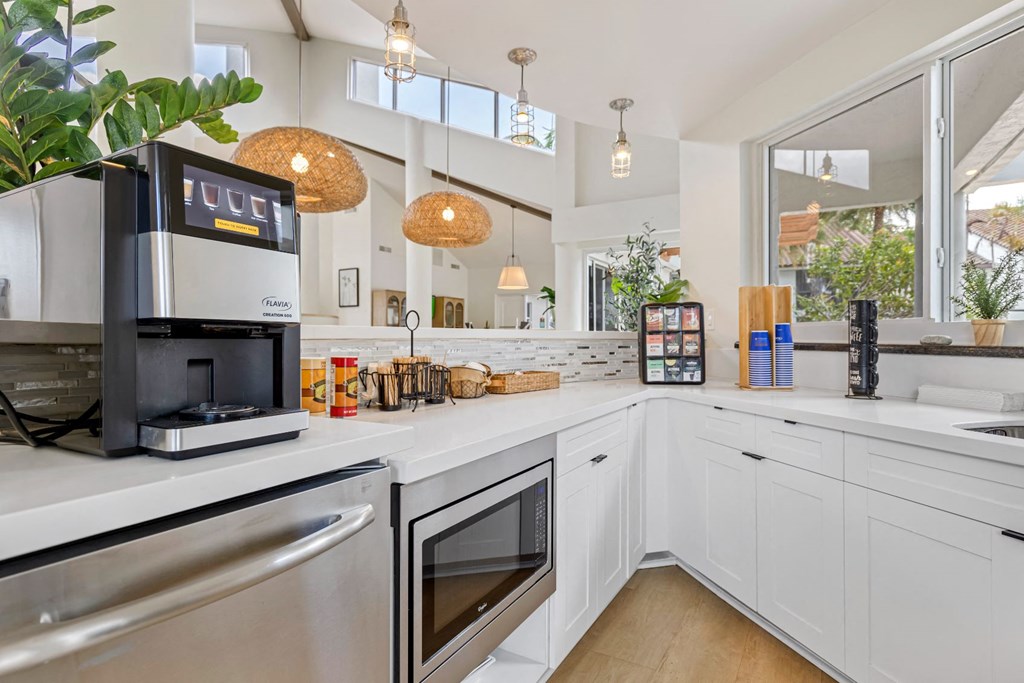 a kitchen with a coffee machine and a sink