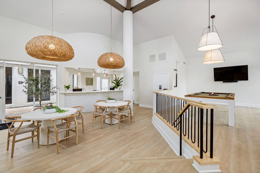 a living room and dining room with a table and chairs