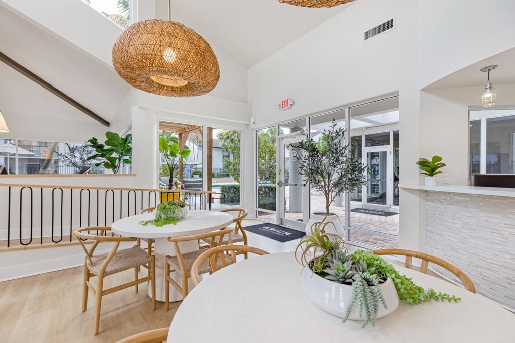 a dining room with a table and chairs and a balcony
